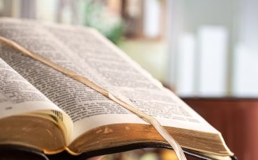 Book Bible close-up, on a beautiful terrace background. Morning time.