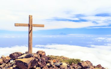 Christian cross on mountain top