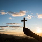 Silhouette of Hand hold cross of God